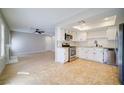 Bright kitchen featuring stainless steel appliances, white cabinets, and tile flooring at 6649 W Tropicana Ave # 101, Las Vegas, NV 89103