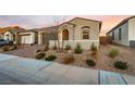 Charming single-story home with brick driveway, two-car garage, stone accents, and desert landscaping at 76 Tatahatso Point St, Henderson, NV 89011
