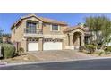 Beautiful two-story home featuring manicured landscaping, a three-car garage, and a lovely terracotta roof at 7641 Jacaranda Bay St, Las Vegas, NV 89139