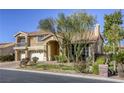 Stunning two-story home featuring a terracotta roof, manicured landscaping, and a three-car garage at 7641 Jacaranda Bay St, Las Vegas, NV 89139