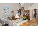 Spacious living room featuring vaulted ceilings, a staircase, and abundant natural light at 8125 Boxberry Ave, Las Vegas, NV 89131