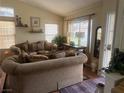 Cozy living room with ample seating, large windows, and neutral decor at 8154 Flanders Terrace Dr, Las Vegas, NV 89123