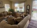 Inviting living room featuring comfortable seating, natural light, and stylish decor at 8154 Flanders Terrace Dr, Las Vegas, NV 89123