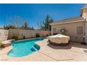 Beautiful backyard swimming pool with steps and lounge area for relaxing at 8266 Lincoln Valley St, Las Vegas, NV 89123