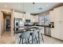 Modern kitchen featuring stainless steel appliances, granite countertops, and an island with seating at 8490 Classique Ave # 101, Las Vegas, NV 89178