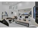 Open-concept living room featuring high ceilings, contemporary decor, and lots of natural light at 8717 Kingship Ct, Las Vegas, NV 89129