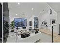 Spacious living room with sleek furnishings, large windows, and modern decor at 8717 Kingship Ct, Las Vegas, NV 89129