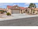 Charming single-story home with a red tile roof, desert landscaping, and a two-car garage at 8812 Stoney Point Dr, Las Vegas, NV 89134