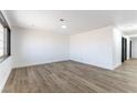 Spacious living room with recessed lighting, wood-look floors, and freshly painted white walls at 887 W Carey Ave, North Las Vegas, NV 89030