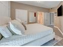 Serene main bedroom showcasing a king bed, ensuite bathroom, and calming neutral tones at 10001 Peace Way # 1321, Las Vegas, NV 89147
