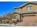 Attractive home with a two-car garage, complemented by green landscaping and a clear blue sky at 10398 Addie De Mar Ln, Las Vegas, NV 89135