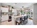 Modern kitchen with stainless steel appliances, a large island with seating, and a stylish pendant light at 10847 Intro Ave, Las Vegas, NV 89135