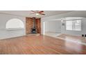 Open concept living room with wood flooring, fireplace, and plenty of natural light at 1113 Date St, Las Vegas, NV 89108