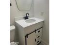 Bathroom vanity with white countertop, black faucet, and sliding barn door detail at 1297 Peppercorn Ave, Henderson, NV 89012
