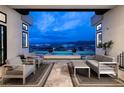 Inviting patio with stylish seating area overlooking a tranquil pool and captivating city views at 148 Tre Pietre St, Henderson, NV 89011