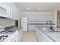 Kitchen features granite countertops, white appliances, and tile flooring at 1717 Chase Glenn Ct, North Las Vegas, NV 89086