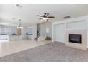 Open-concept living space with fireplace, ceiling fan, and staircase leading to the second floor at 1717 Chase Glenn Ct, North Las Vegas, NV 89086