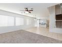 Bright living area with large windows, ceiling fan, and seamless access to the kitchen at 1717 Chase Glenn Ct, North Las Vegas, NV 89086
