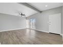 Spacious living room featuring sleek floors, a ceiling fan, natural light, and a modern design at 1906 Palora Ave, Las Vegas, NV 89169