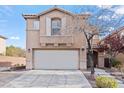 Two-story home featuring a two-car garage, desert landscaping and a well-maintained front yard at 2624 Courlan Dr, North Las Vegas, NV 89084