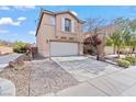 Two-story home featuring a two-car garage and low-maintenance desert landscaping at 2624 Courlan Dr, North Las Vegas, NV 89084