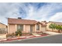 A single story home featuring a red tile roof, security bars on the windows and mature landscaping at 2735 Poppyseed Way, Las Vegas, NV 89142