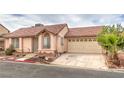 Street view of a single-story home featuring a red tile roof and a two car garage with mature landscaping at 2735 Poppyseed Way, Las Vegas, NV 89142
