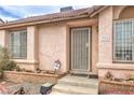 Close-up of the front entrance, featuring a security door, house number, and mature landscaping in the front yard at 2735 Poppyseed Way, Las Vegas, NV 89142