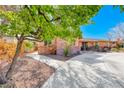 Well maintained single-story home with a stone and brick facade featuring a concrete driveway and stone landscaping at 2809 Gilmary Ave, Las Vegas, NV 89102