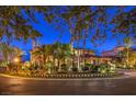 Beautifully landscaped home exterior at twilight, featuring mature trees and elegant lighting at 2994 San Lorenzo Ct, Henderson, NV 89052