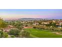 Scenic view of a lush golf course with homes and mountain backdrop at 2994 San Lorenzo Ct, Henderson, NV 89052