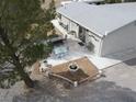 Aerial view of a backyard featuring an outdoor kitchen, ample seating, a firepit, and desert landscaping at 4861 Pahrump Valley Blvd, Pahrump, NV 89048