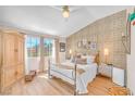 Comfortable bedroom with decorative wall, natural light, and ample closet space at 4921 Cedar Lawn Way, Las Vegas, NV 89130