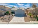 Charming single-story home with well-maintained landscaping and attached two-car garage at 4921 Cedar Lawn Way, Las Vegas, NV 89130