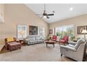Bright living room boasts vaulted ceilings, neutral walls, and large windows with plantation shutters, plus comfortable seating arrangement at 5205 Sandy Cactus Ln, Las Vegas, NV 89149