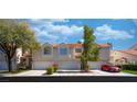 Charming townhome featuring a two-car garage, red-tile roof and manicured landscaping at 5256 Harvest Breeze Rd, Las Vegas, NV 89118