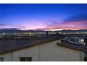 Breathtaking city view at twilight, featuring a panorama of city lights and mountain silhouette against the colorful sky at 532 Crown Mesa Ave, Las Vegas, NV 89138