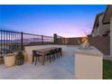 Relaxing outdoor patio with a dining table set and a built-in BBQ area, perfect for entertaining in style at 532 Crown Mesa Ave, Las Vegas, NV 89138