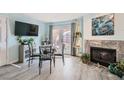 Dining area with a fireplace, stylish furniture, and access to the exterior at 6883 Tamarus St # 203, Las Vegas, NV 89119