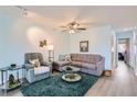 Comfortable living room featuring a plush sectional sofa and a cozy armchair at 6883 Tamarus St # 203, Las Vegas, NV 89119