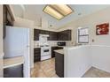 Bright kitchen featuring a gas range, tiled floors, and a breakfast bar at 6982 Rusty Nail Way, Las Vegas, NV 89119