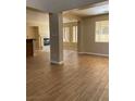 Spacious living room featuring wood-look tile flooring, fireplace, and neutral paint colors at 7439 S Pioneer Way, Las Vegas, NV 89113