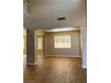 Bright living room with high ceilings, wood-look tile flooring and plenty of natural light at 7439 S Pioneer Way, Las Vegas, NV 89113