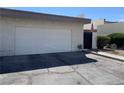 Charming home featuring a two-car garage and well-maintained landscaping with a touch of American pride at 774 Anne Ln, Henderson, NV 89015