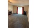 Bright living room boasts a cozy fireplace, soft carpet, and sliding doors providing ample light at 774 Anne Ln, Henderson, NV 89015
