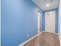 Inviting entryway features hardwood floors and a freshly painted blue accent wall for a modern look at 816 Stannard Ct, Henderson, NV 89052