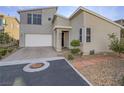 Contemporary two-story home boasts a two-car garage, desert landscaping, and neutral exterior paint at 816 Stannard Ct, Henderson, NV 89052