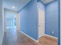 Hallway with blue accent wall and recessed lights leads to living area and bedroom at 816 Stannard Ct, Henderson, NV 89052