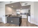 Bright, modern kitchen featuring stainless steel appliances, a stylish island, and ample cabinet space at 8777 W Maule Ave # 3090, Las Vegas, NV 89148