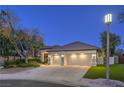 Inviting home featuring a well-manicured front yard and a spacious three-car garage at 1900 Vero Dr, Las Vegas, NV 89134